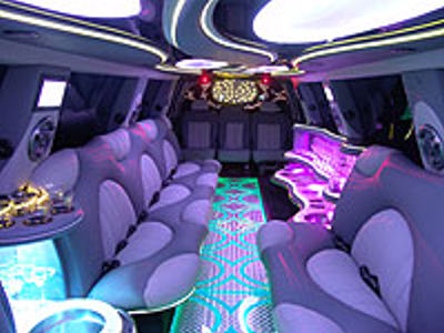 Chauffeur stretch pink Hummer H2 limousine hire interior in UK